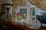 A few of the large collection of crystal bells with different birds on top.