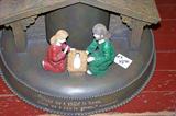 This is a close-up of the Christmas tree stand - depicting the manger scene with scripture on the front of the base.