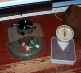 This picture shows two unique items - an old English scale and a wonderful heavy iron Christmas tree stand.