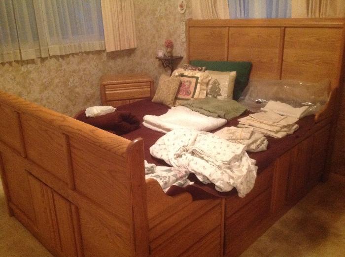 Oak queen size captains bed with storage drawers on each side and storage through the center