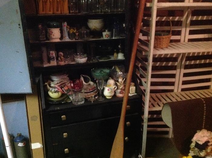 Antique cabinet three shelves on top three drawers on the bottom lots of miscellaneous glassware rowing oar