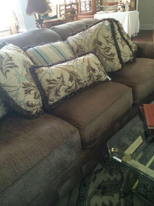                 Leather sofa with decorative pillows