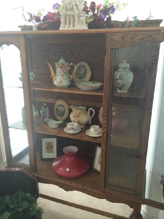            Antique curio cabinet with collectibles