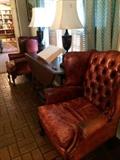 Two of four red wingback leather chairs, drop-leaf table, and pair of matching lamps