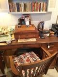     Antique desk, office chair, and many books