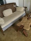    Cane back sofa and "camel saddle" footstool