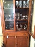Antique storage cabinet and large selection of glassware