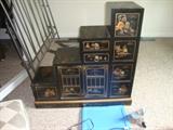 Stair stepped Oriental black lacquerware and hand painted chest of drawers.