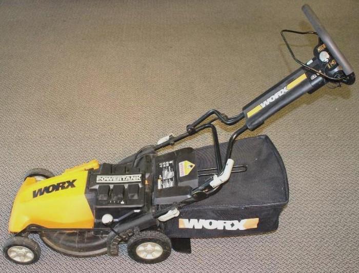 LAWN MOWER - WORX 24v Rechargeable Electric Lawn Mower. Mulching mower comes with side-discharge chute, rear bag, and charger. Handel folds for easy storage. Working condition, not fully tested.