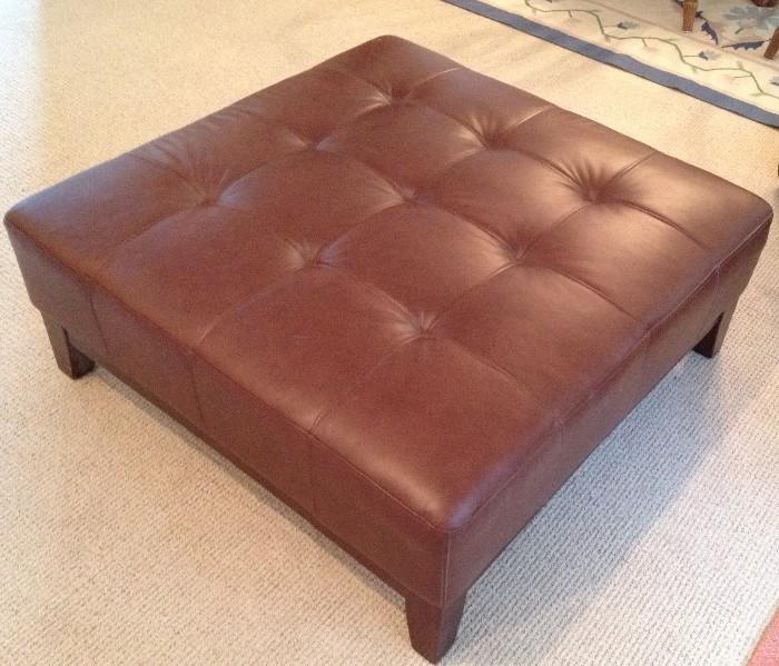 Faux leather tufted ottoman