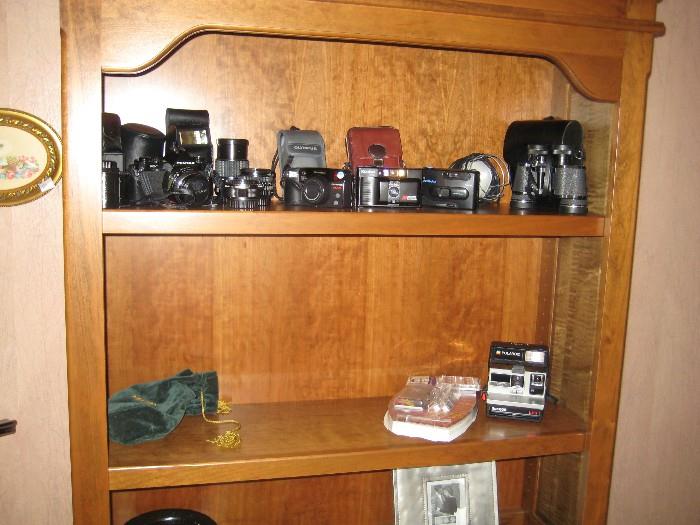 Well traveled collection of cameras.  Pentax, Konica, Polaroid