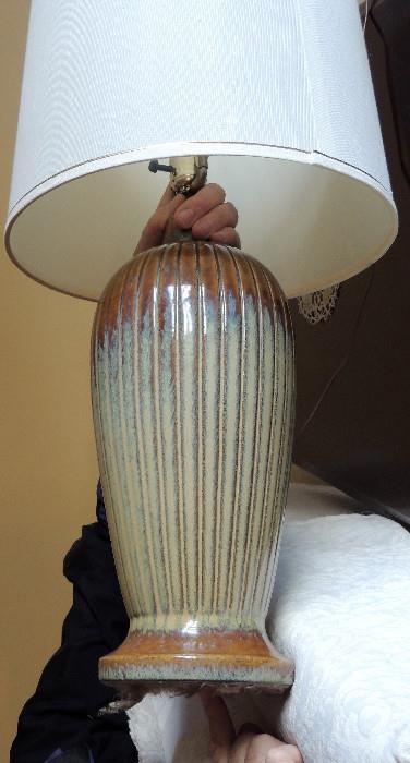 One of a pair of ribbed pottery lamps with flambe glaze.