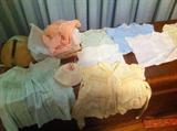 lots of vintage baby clothes with hangers