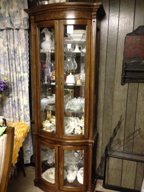 Rounded Glass China Cabinet Full Of Beautiful Collectibles