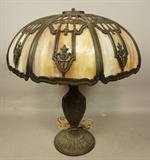 Lot 17  -  Antique slag glass table lamp. Possibly Bradley and Hubbard. Patina to metal.-- Dimensions:  H: 21.5 inches: W: 18.5 inches: D: 18.5 inches --- 