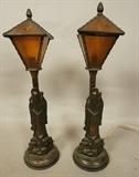 Lot 19  -  Pair of metal figural table lamps. Asian style with amber glass tops.-- Dimensions:  H: 16 inches: W: 4 3/4 inches: D: 4 3/4 inches --- 