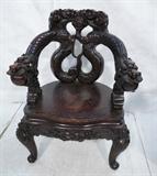 Lot 117  -  Heavily Carved Chinese Arm Chair with Dragons and Bats.  -- Dimensions:  H: 34 inches: W: 31 inches: D: 24 inches --- 