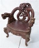 Lot 121  -  Chines Carved Arm Chair with Dragons and Winged Creatures.  Inlaid Eyes.  -- Dimensions:  H: 38 inches: W: 28 inches: D: 23 inches --- 