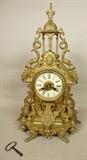 Lot 196  -  Antique Brass Mantle Clock with Porcelain Dial.  Figural clock with griffins.-- Dimensions:  H: 22 inches: W: 14 inches: D: 6 inches --- 