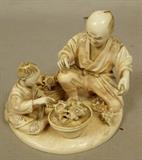 Lot 246  -  Carved Japanese ivory sculpture man with child and baskets of seashells. Signed. -- Dimensions:  H: 4 inches: W: 4.5 inches: D: 4 inches ---  <br><br>US Shipping charge:</b>  $20