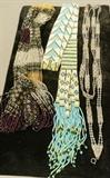 Lot 270  -  3 piece woven seed bead necklaces. 1) Lariat form with white blue and yellow seed beads, tassel ends. 2) Long silver and gold bead necklace. 3) Multi-strand necklace with decorative detail.-- Dimensions:  : L: 42 inches ---  <br><br>US Shipping charge:</b>  $20