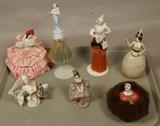 Lot 216  -  7pc Porcelain Half Doll Brushes. Figural Lady Boxes with Lids. 1). Pin Cushion: Woman with Pink Ribbon Skirt. 2) & 3). Porcelain Half Doll Brushes. 4) & 5). Figural Boxes with Lid. 6). Porc. Half Doll. 7). French Porcelain Ladies Head with fur "powder Puff"? -- Dimensions:  H: 8.75 inches ---  <br><br>US Shipping charge:</b>  $35