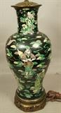 Lot 319  -  Large Ceramic Asian Pottery Table Lamp. Polychrome Glazed with Figures and Clouds. Asian inspired brass base. Pierced dragon brass top. -- Dimensions:  H: 24 inches: W: 8.5 inches --- 