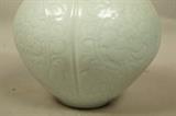 Lot 320  -  Celadon Glazed Porcelain Vase. Carved Ceramic Body with light pale celadon glaze. Lobed form. Signed. -- Dimensions:  H: 10.5 inches: W: 9.5 inches: D: 9.5 inches --- 