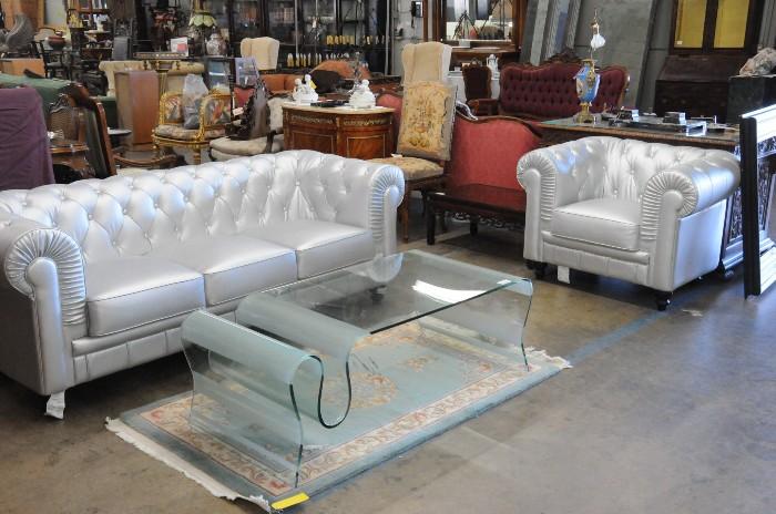 Silver upholstered tufted sofa and club chair, contemporary molded glass coffee table