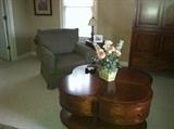 4 leaf clover coffee table with 4 drawers and bottom storage shelf. Looks new. Club chair and side table with lamp.