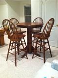 Like new 36" round bar table and 4 swivel barstools