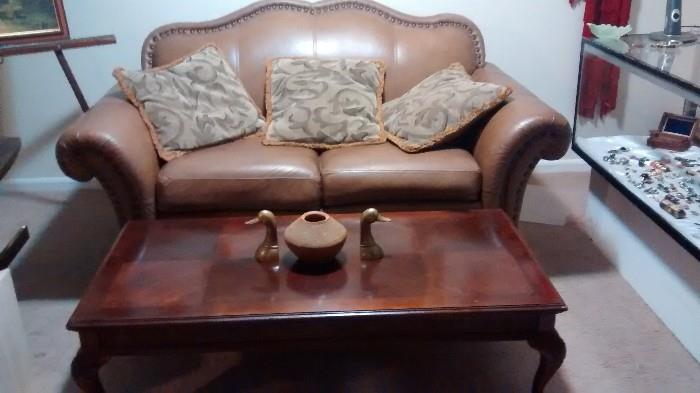 leather love seat and coffee table