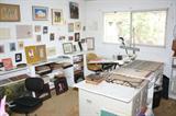several desks and drafting table and file cabinets make up this room