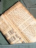 Helicopter flak jacket, USN gas mask, flight helmet, goggles and cover, pictures and news paper info