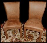 Two leather covered straightback chairs