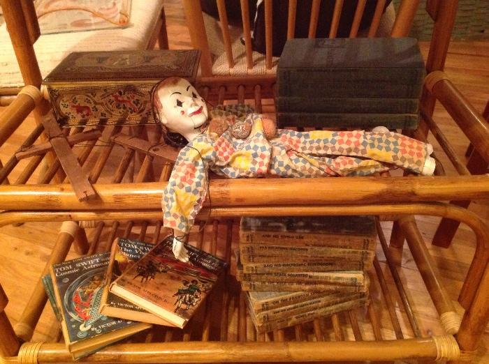 Several colorful Tom Swift books and a vintage marionette