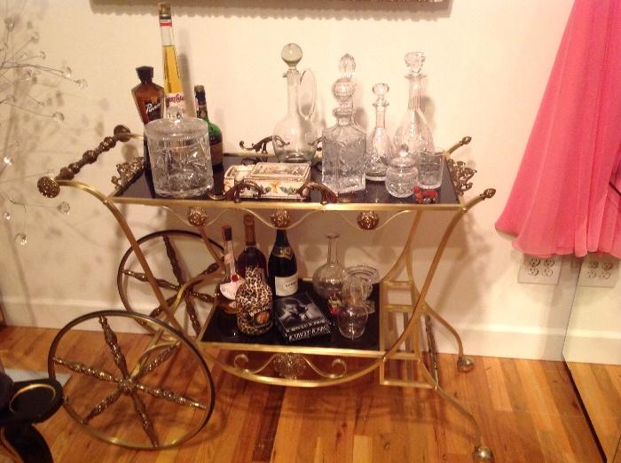 This is such a unique bar cart, totally Hollywood Regency and filled with great decanters