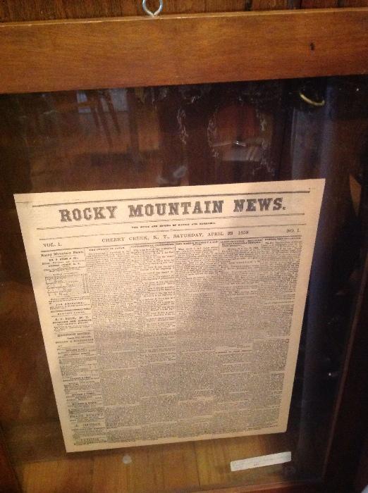 This is a framed copy of the first printing of the Rocky Mountain News front page
