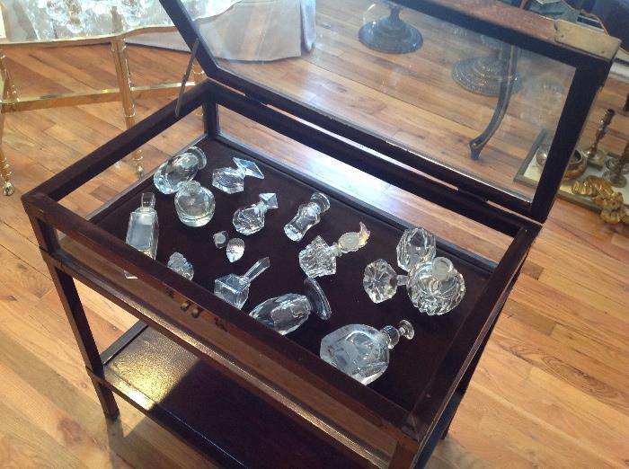Lovely collection of glass perfume bottles and great curio display table / case
