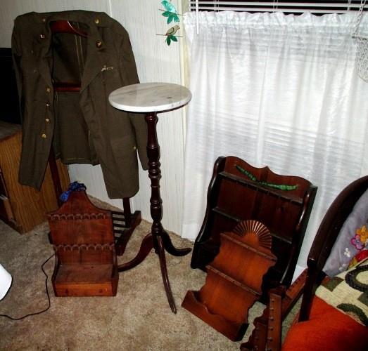 Pedestal table, five wooden spoon racks, WW II US Army uniform..