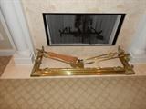 Brass fireplace fender and fireplace tools.