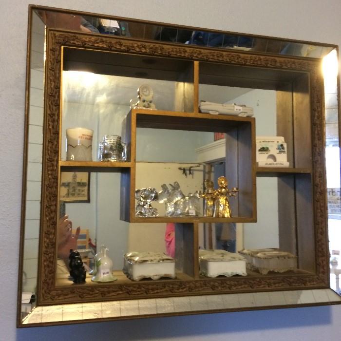 Great mirror wall shelf with some stuffy stuff
