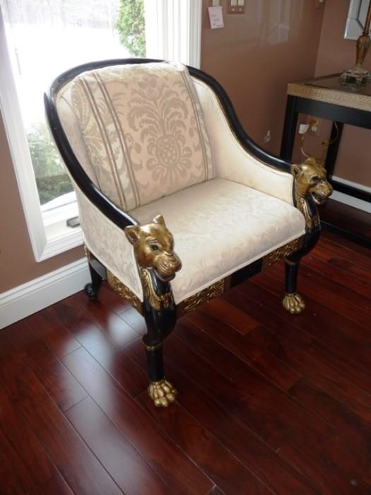 1 OF A PAIR - CARVED BLACK LACQUER ARMCHAIRS WITH GILDED PANTHER HEADS AND FEET.