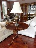 ANTIQUE-STYLE CARVED MAHOGANY TILT-TOP TABLE WITH BALL/CLAW FEET.