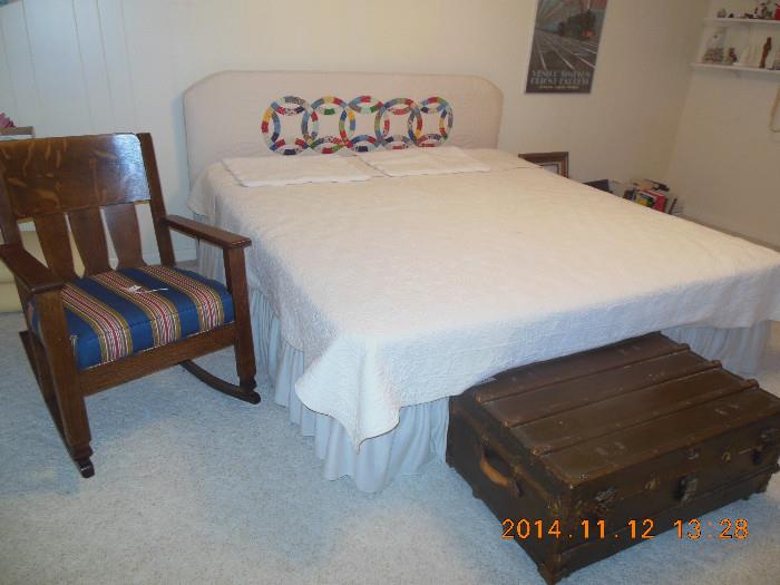 King size bed with mattress,  quilted head board, comforter and shams.  Pllese note the vintage storage trunk flat top train luggage chest . A great rocker with a newly upholstered seat.