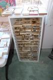 Massive amount of wooden/rubber stamps. Great open cabinet for storage with Lucite drawers.