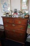 Antique high boy. Candles and trinket boxes.