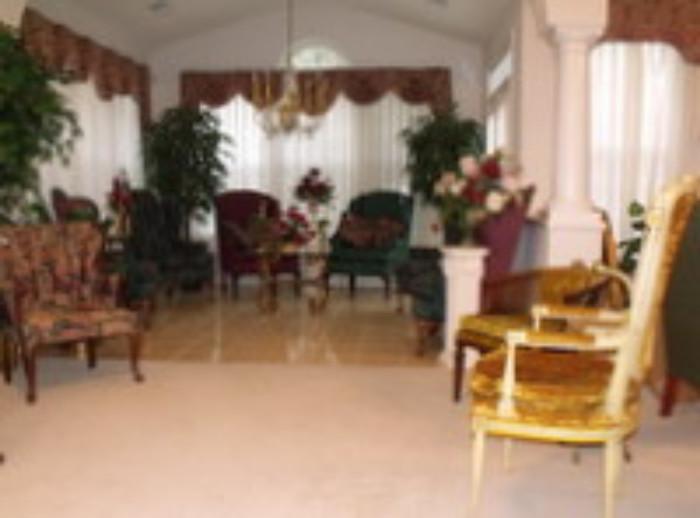 Many wing chairs and occasional tables 