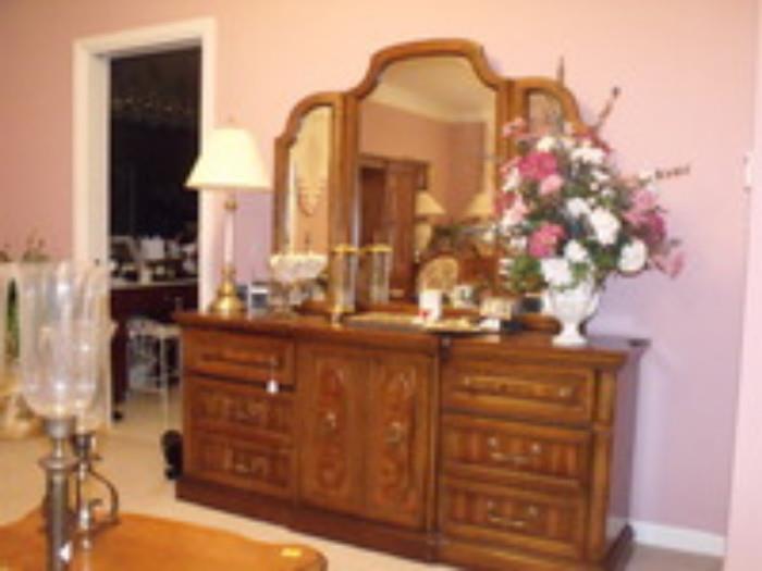 Vintage dresser, lamps and floral arrangements 