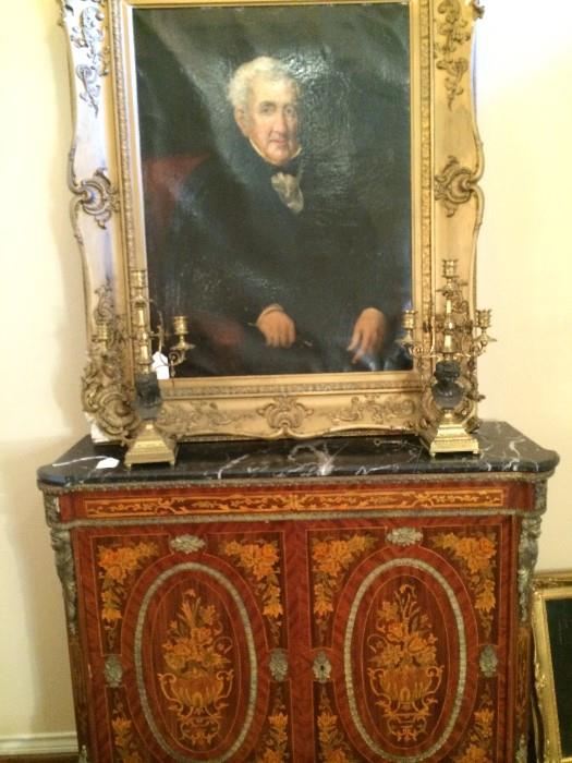 Exquisite  antique marble top chest; pair of brass candelabras;  framed portrait.